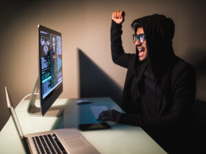 indian-hacker-wear-mask-using-laptop-empty-white-room.jpg