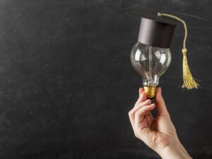 person-holding-light-bulb-with-graduation-cap.jpg