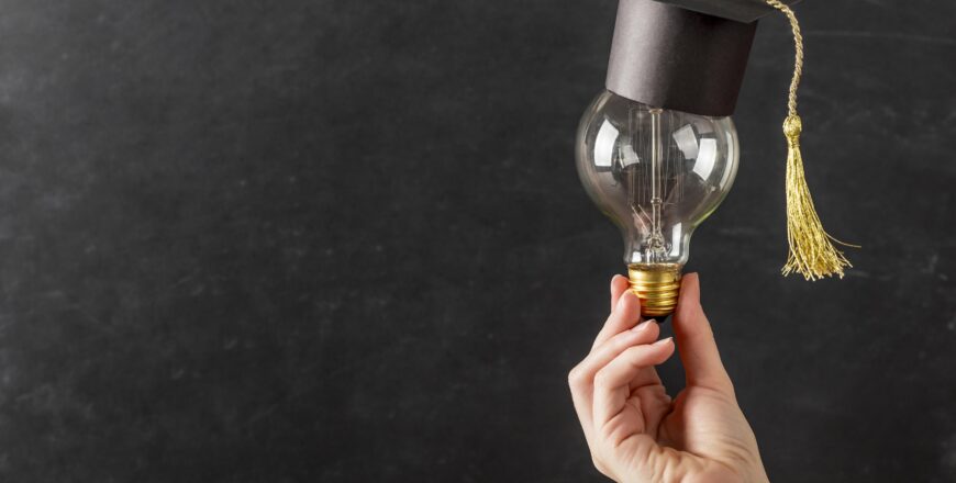 person-holding-light-bulb-with-graduation-cap.jpg